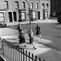 Girls dancing around a street lamp post used as a makeshift maypole Image preview