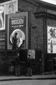 A billboard paster works to complete an advert in Chalk Farm Road, Camden Image preview