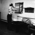 A man has a shave in a public toilets Image preview
