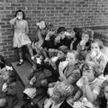 Children drink milk at a Holiday Play Centre at Woodburydown Image preview