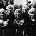Young visitors to the Schoolboys Own Exhibition held at Olympia in fancy dress costume and helmets Image preview
