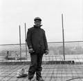 A black builder poses for the camera during the topping out of new flats in Treby Street, Mile End Image preview