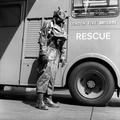 A fireman in the London Fire Brigade stands beside an engine at LFB Headquarters wearing a draegar suit Image preview