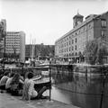 Young people sit on the quayside at St. Katharine's Dock Image preview