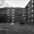 Children playing on the grass outside newly built flats in Peckham Image preview