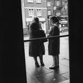 Two women standing talking on a street in Kentish Town Image preview