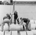 A man repairs a ship moored in a London dock Image preview
