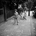 Girls playing hopscotch in the street Image preview