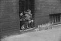 Children sitting on a doorstep Image preview