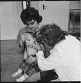 A doctor examines an infant's ear, Burney Street Welfare Centre Image preview