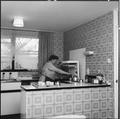 A women in the kitchen of a flat, Marquess Estate Image preview