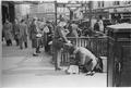 A shoe cleaner polishes boots, Piccadilly Circus Image preview