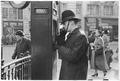 A police officer uses a police call box Image preview