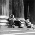 Passers-by rest on the steps of the University of London's main building Image preview