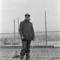 A black builder poses for the camera during the topping out of new flats in Treby Street, Mile End Image preview
