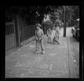 Girls playing hopscotch in the street Image preview